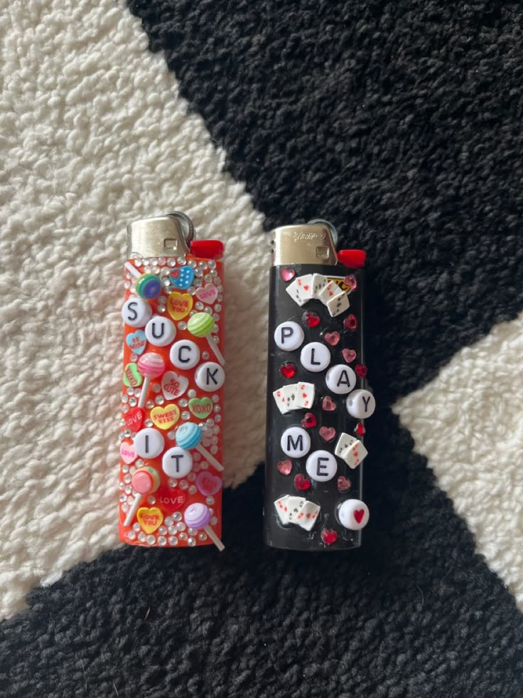 two lighters sitting next to each other on a carpet