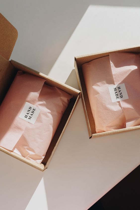 two open boxes sitting on top of a white table next to each other with labels