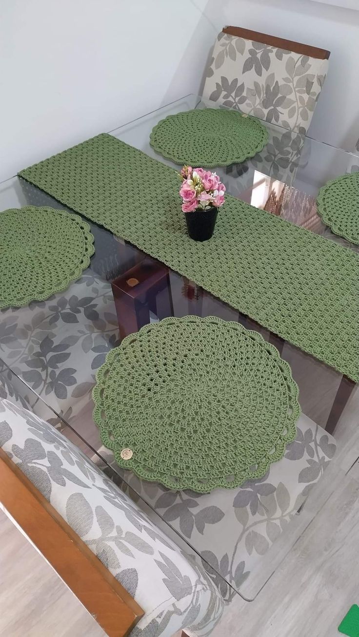 a glass table topped with green place mats