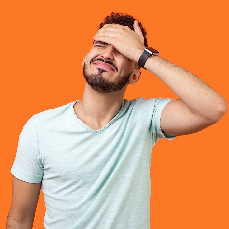 a man is holding his head with one hand and looking up to the sky while wearing a watch