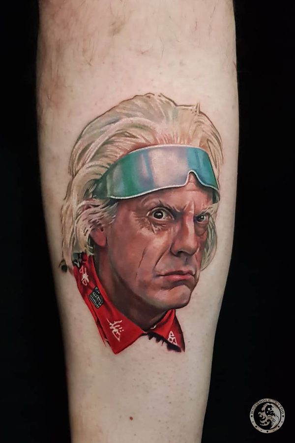 a man's leg with a portrait of an old man wearing goggles on it