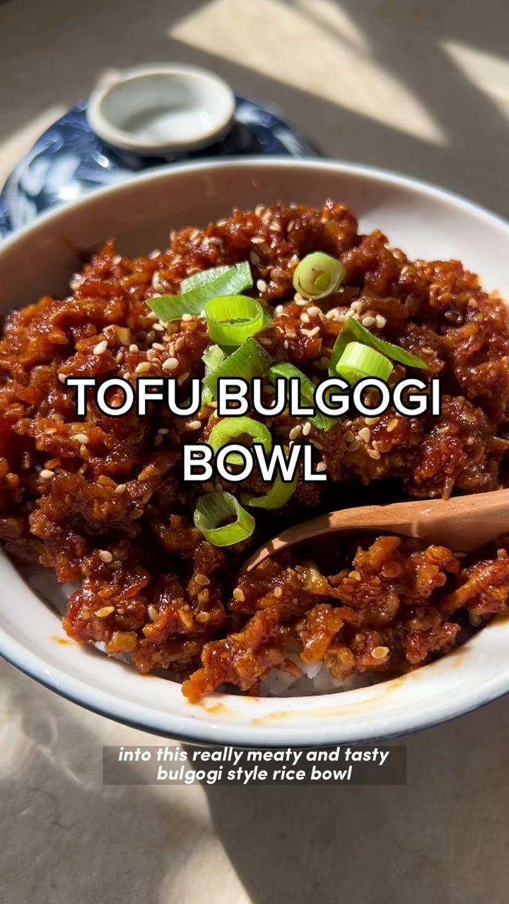 a white bowl filled with food on top of a table