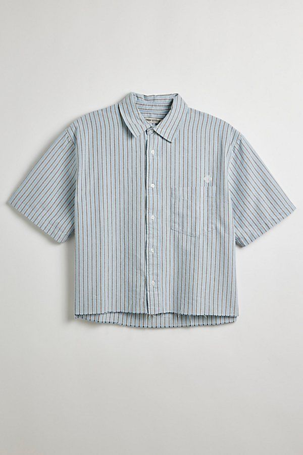 Updated stripe pattern Oxford shirt with a cropped hem. Short sleeve button-down shirt with a standard collar and left chest pocket. Features UO striped cut-off Oxford shirt Short sleeve shirt Standard collar Button-down front Chest pocket Boxy silhouette Cropped hem Content + Care 100% Cotton Machine wash Imported Size + Fit Model in Blue + Grey Stripe 6’2" and wearing size Medium Measurements taken from size Medium Chest: 24" Length: 23.5" | Urban Outfitters UO Striped Cut-Off Oxford Shirt Top Cropped Button Up, Men Wishlist, Cropped Shirt Men, Pastel Mens Fashion, Button Up Shirt Men Outfits, Short Sleeve Button Up Men, Button Up Shirt Men, Striped Shirt Men, Mens Crop Top