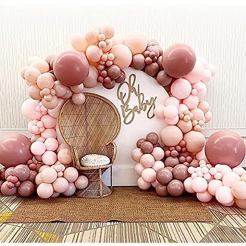 a balloon arch is decorated with balloons and a chair