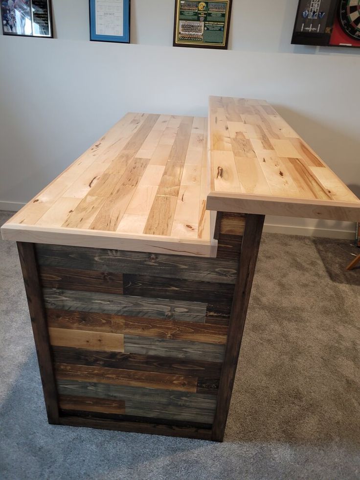 an office desk made out of pallet wood in the middle of carpeted room