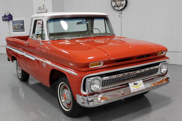 an orange and white truck parked in a garage