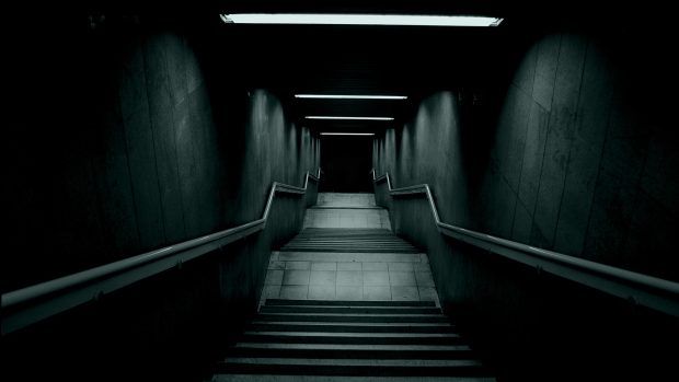 an empty hallway with stairs leading up to the ceiling