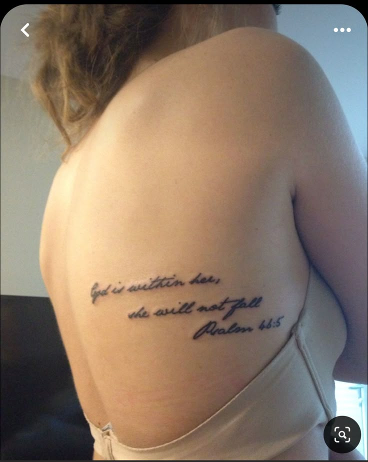 the back of a woman's shoulder with writing on it