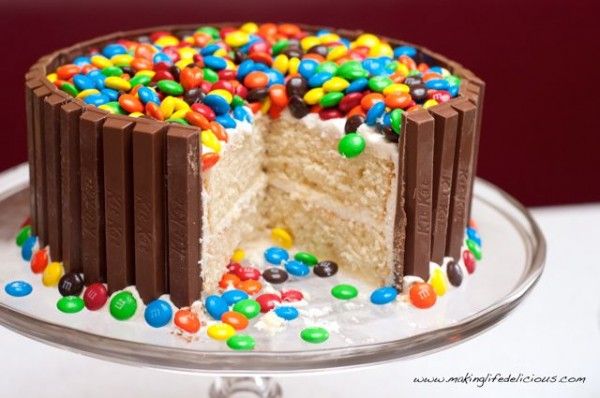 a cake with chocolate frosting and colorful sprinkles on the bottom half