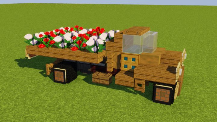 a wooden truck with flowers in the bed