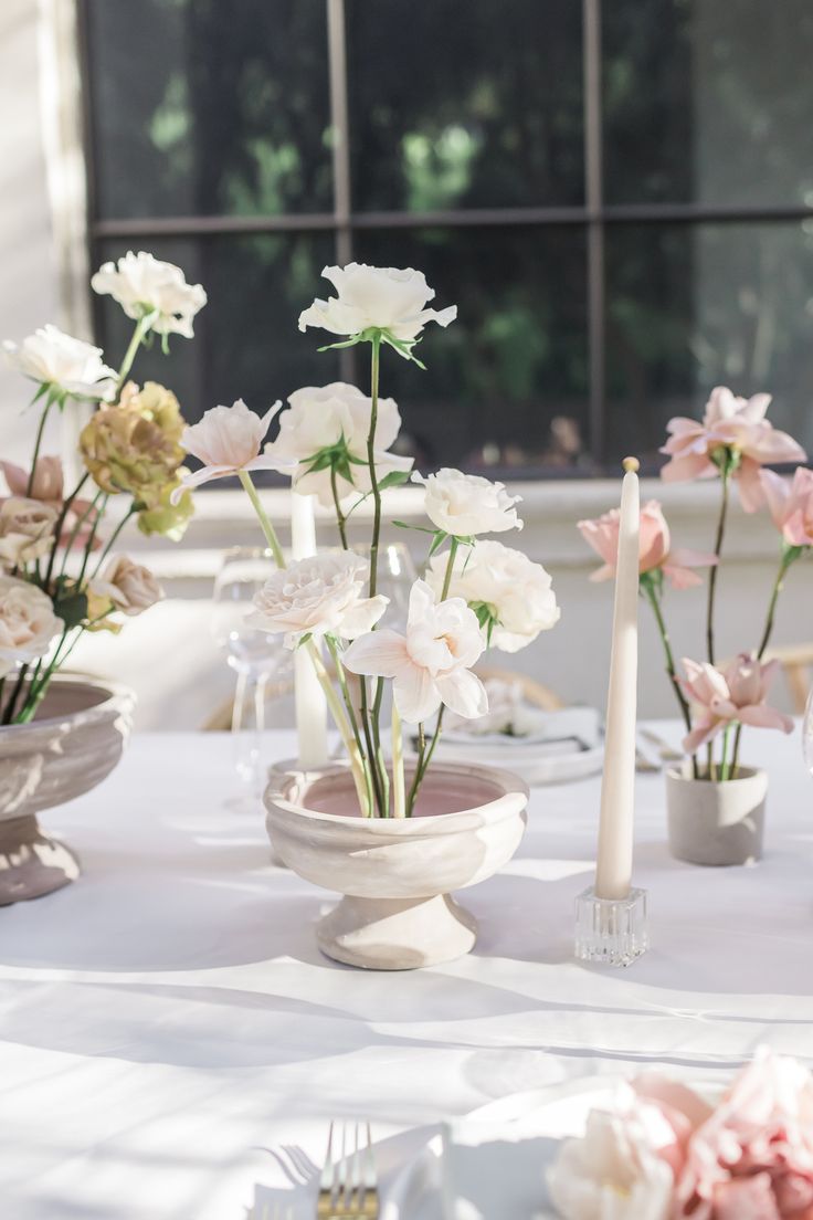 the table is set with flowers and candles