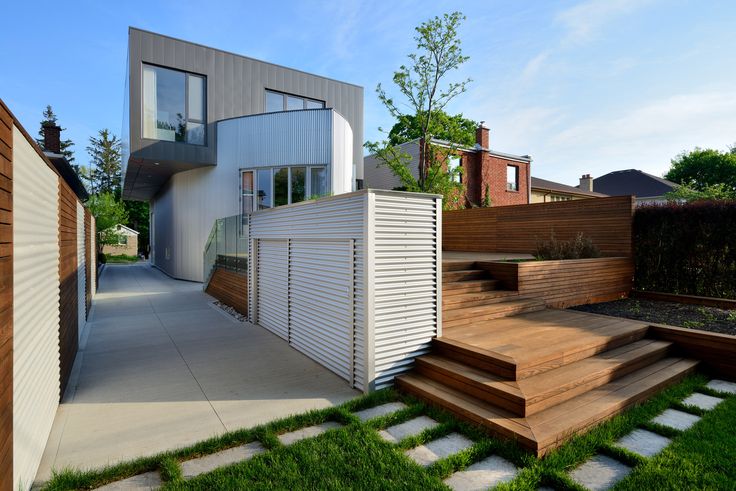 a modern house with wooden steps leading up to it