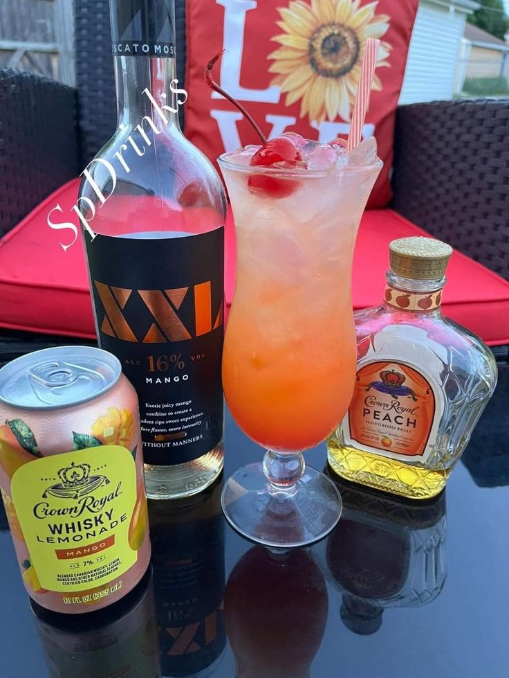 a table topped with bottles and glasses filled with alcohol next to a drink on top of a table