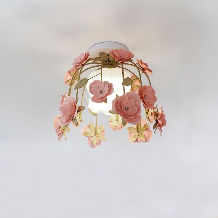 a birdcage with pink flowers hanging from it's sides in the sky