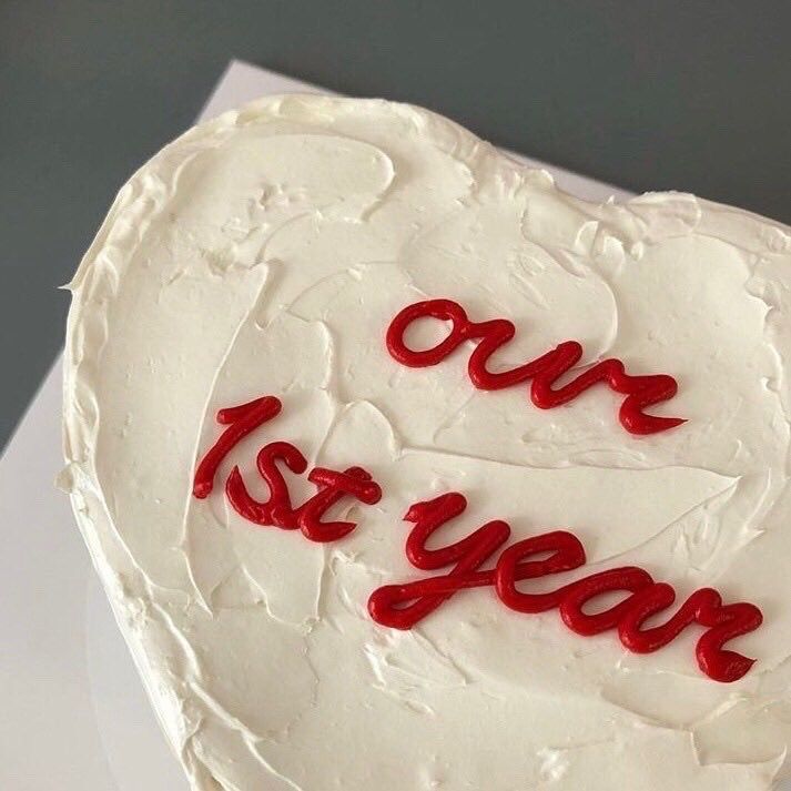 a heart shaped cake with the words our 1st year written on it