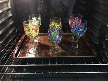 three wine glasses are sitting in the oven