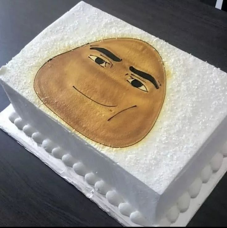 a square cake decorated with an image of a man's face