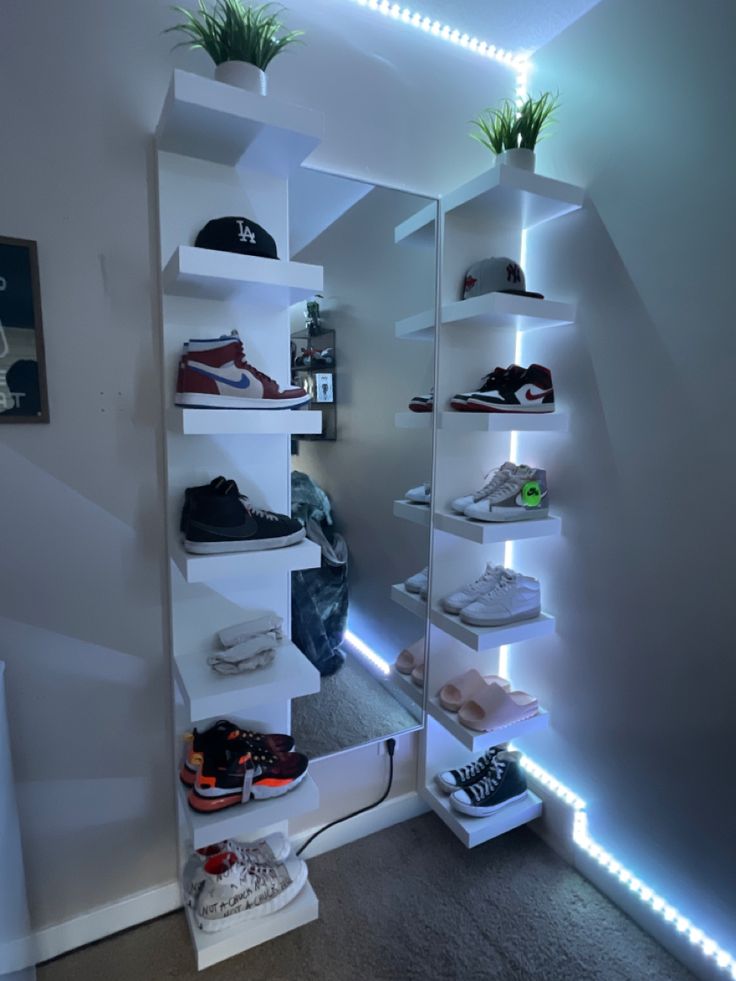 there is a closet with many shoes on the shelves and lights in the room behind it