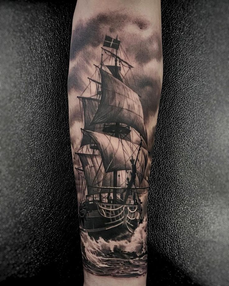 a man's arm with a ship on it