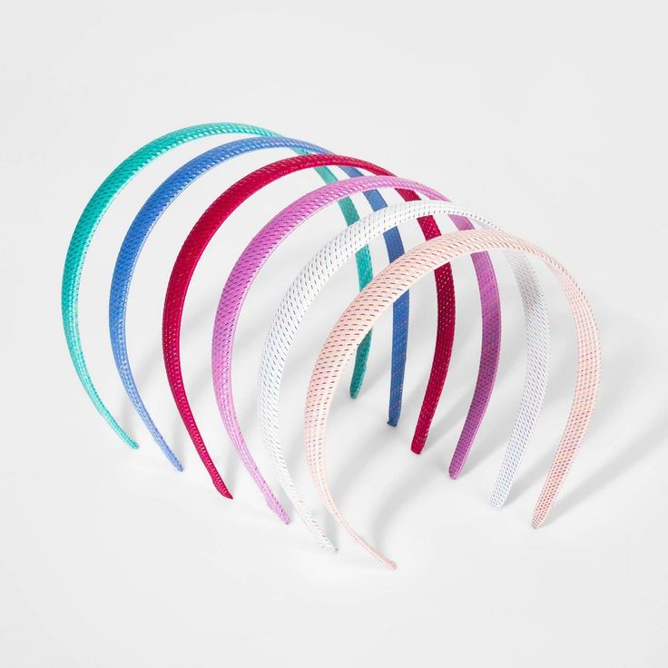 five different colored hair ties on a white surface