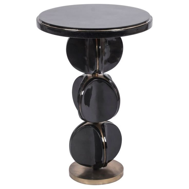 a black and gold side table with three circles on the top, in front of a white background