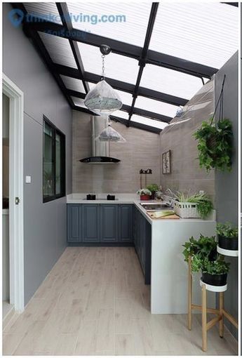 two pictures of a kitchen with wood floors and skylights above the counter top, below an open ceiling