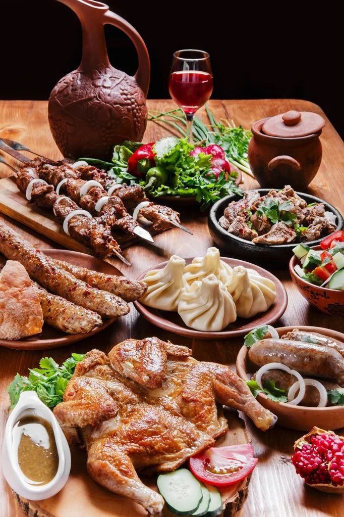 a wooden table topped with lots of different types of meats and veggies