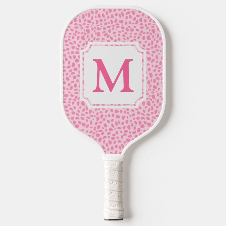 a pink leopard print paddle with the letter m on it