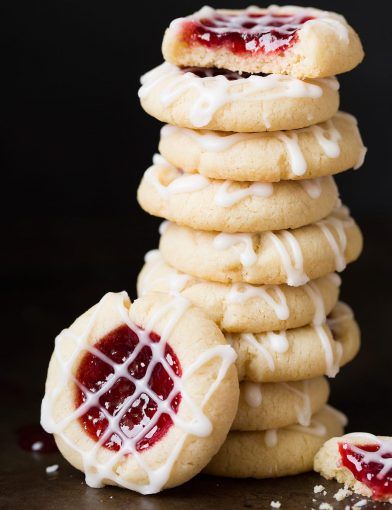 a stack of cookies with white icing and jelly on top