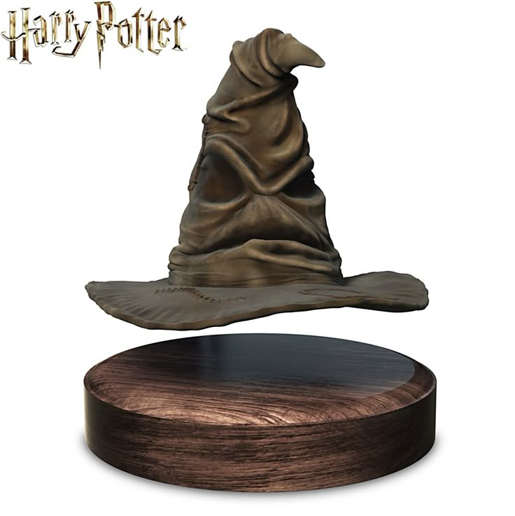 a harry potter hat sitting on top of a wooden base