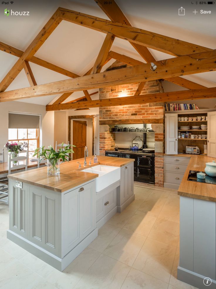 a kitchen with an island and wooden beams