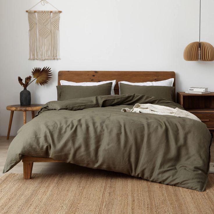 a bed sitting on top of a wooden floor in a bedroom