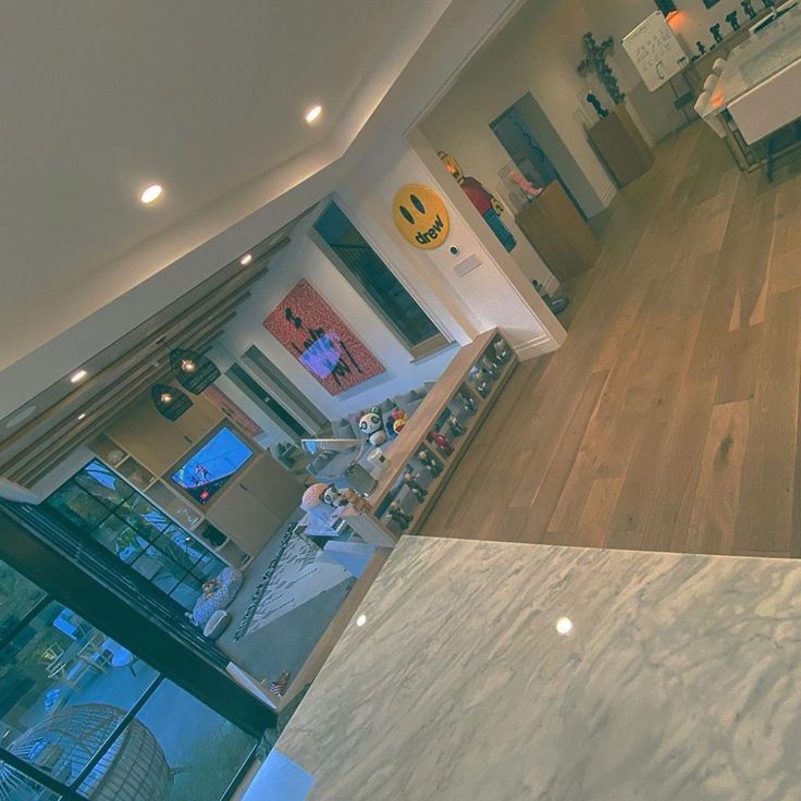 an aerial view of a kitchen and living room from the top floor looking down on the dining area