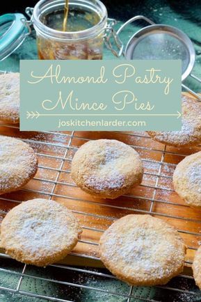 powdered sugar cookies cooling on a wire rack with jar of jam in the background