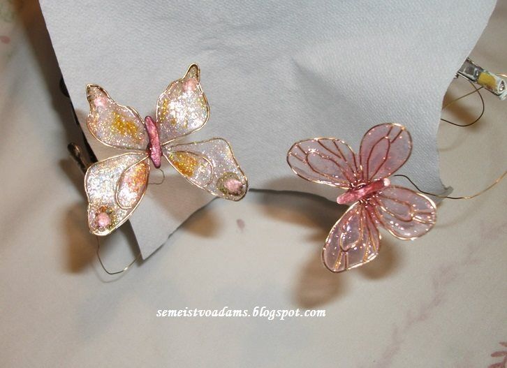 two glass butterflies sitting on top of a table