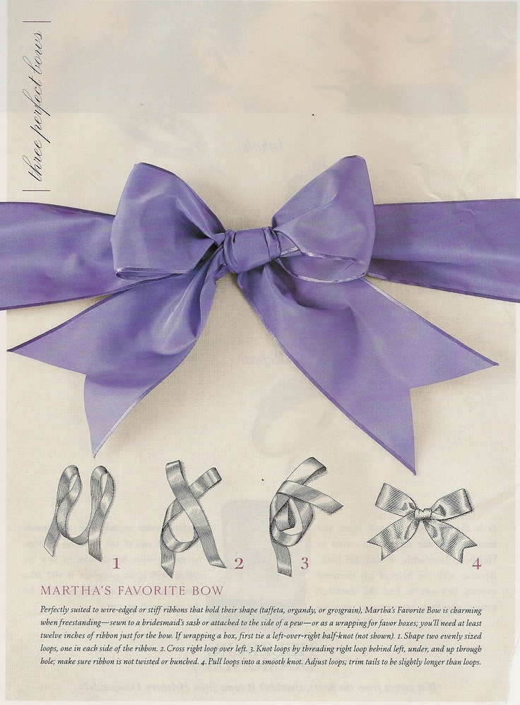 a purple bow on top of a piece of paper