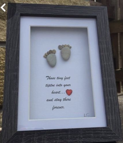 a frame with two baby feet and a heart