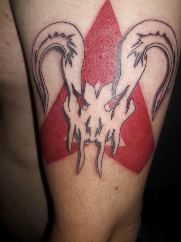 a man's arm with a red triangle and two birds on it, in the shape of a heart