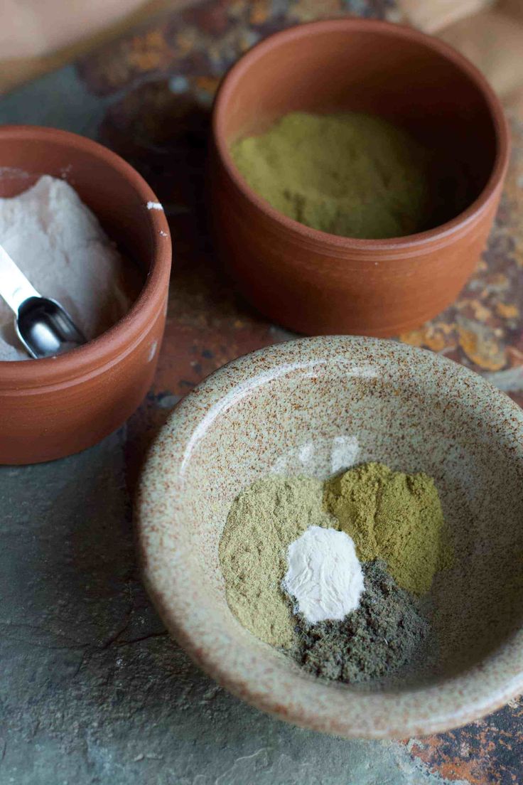 two clay bowls filled with different types of powder