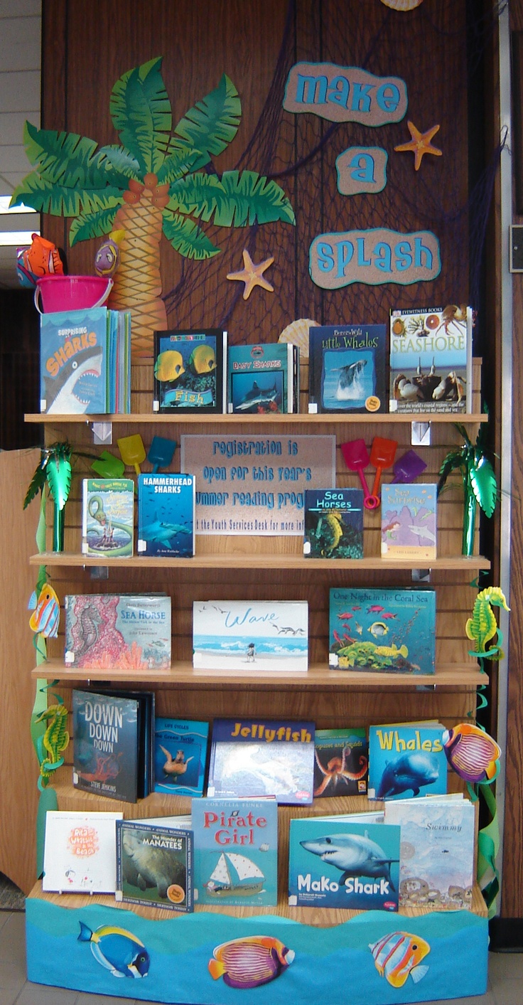 there is a book display with books on the shelves and palm trees in the background