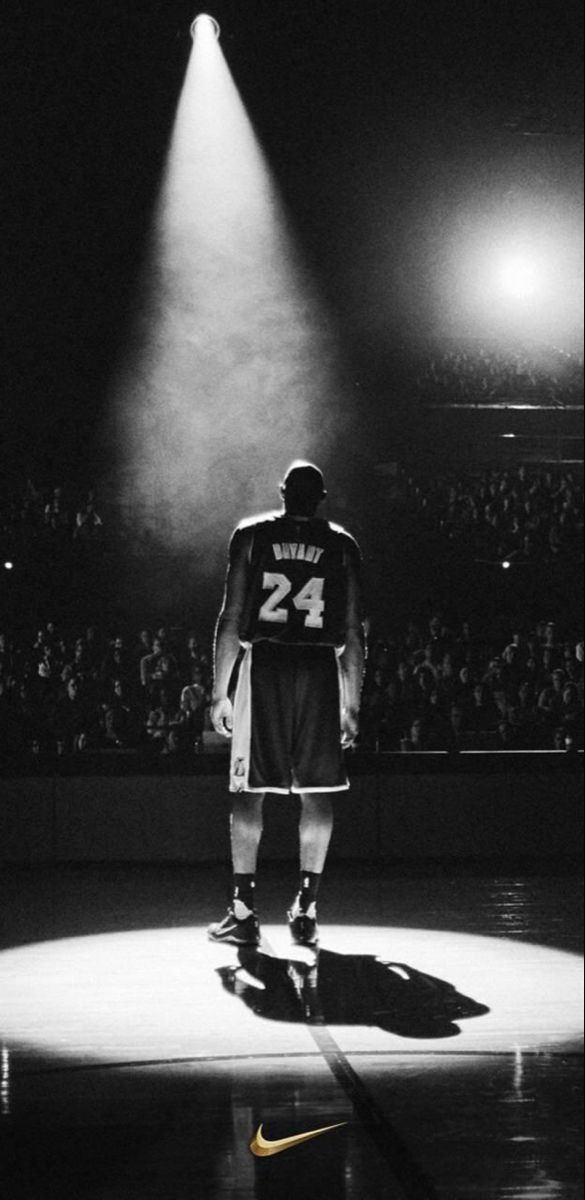 a basketball player standing in the middle of a court with his back to the camera