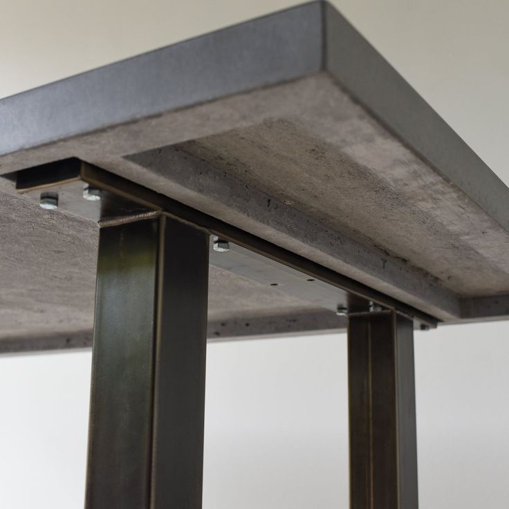 an image of a metal table top that is made out of concrete and steel beams