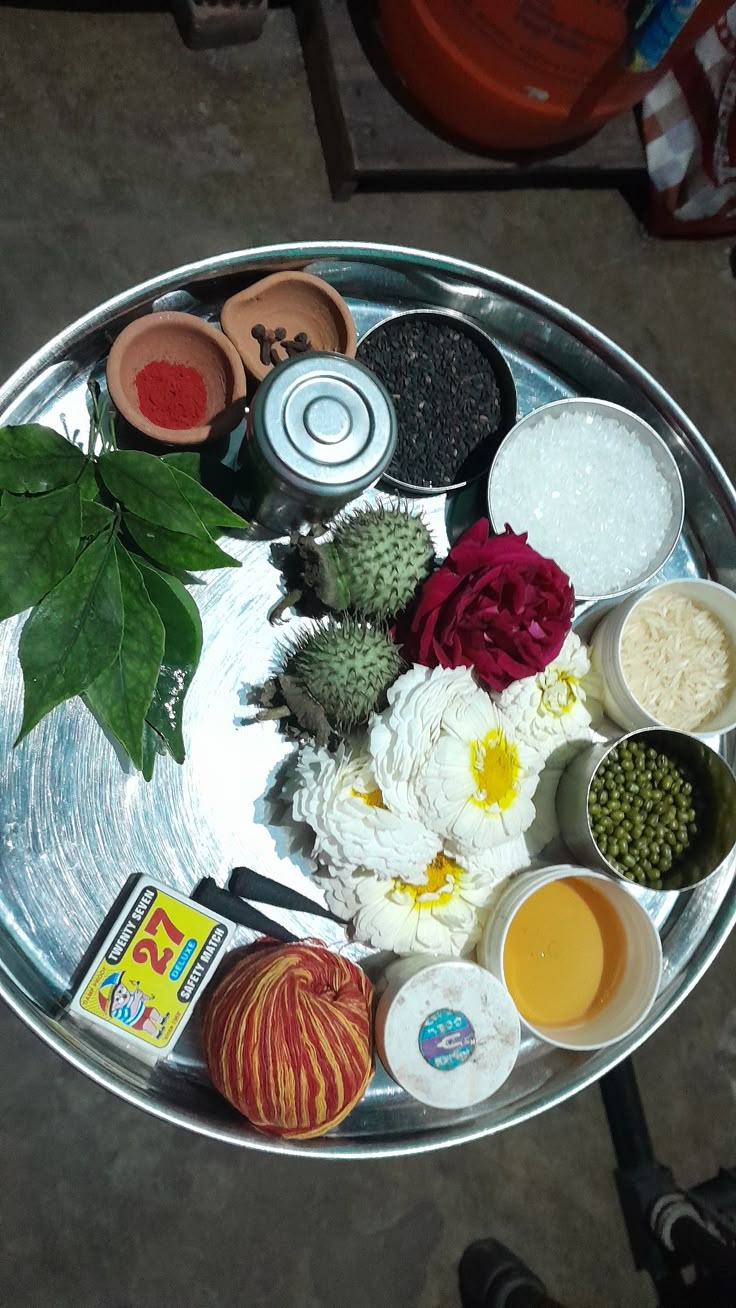 a metal tray topped with lots of different types of food and condiments on top of it