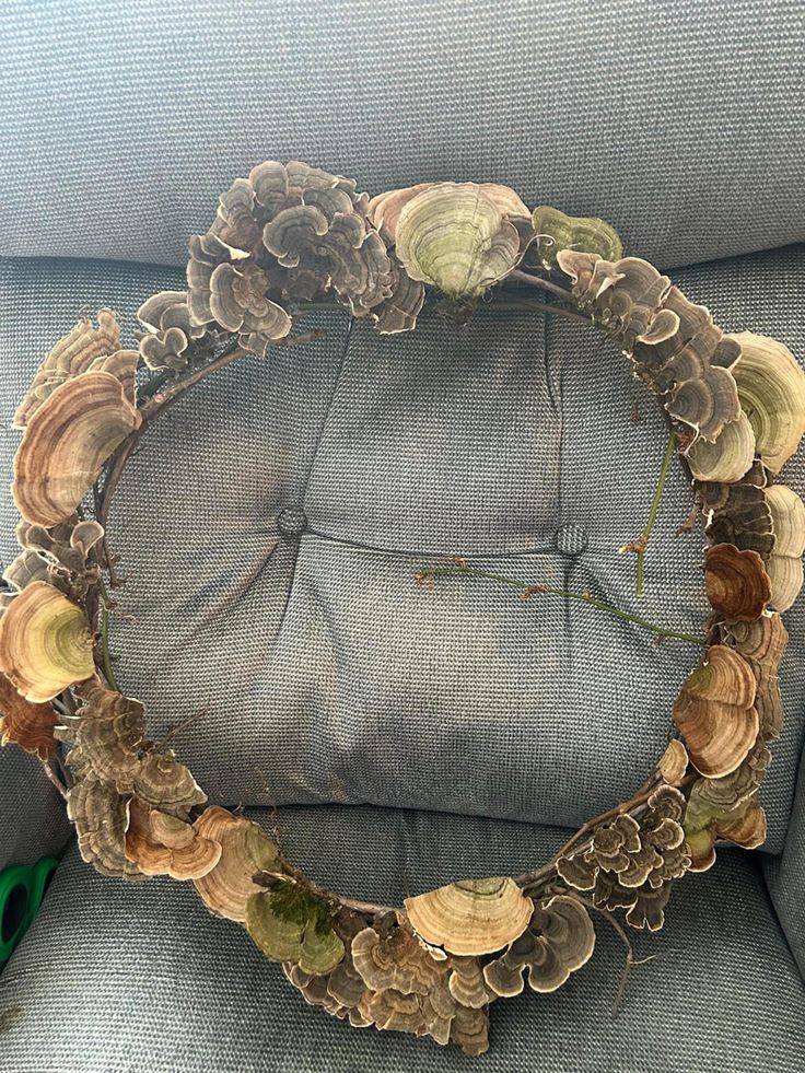 a wreath made out of seashells sitting on top of a chair