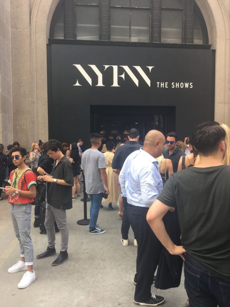 many people are standing in front of the nyny show entrance and looking at their phones