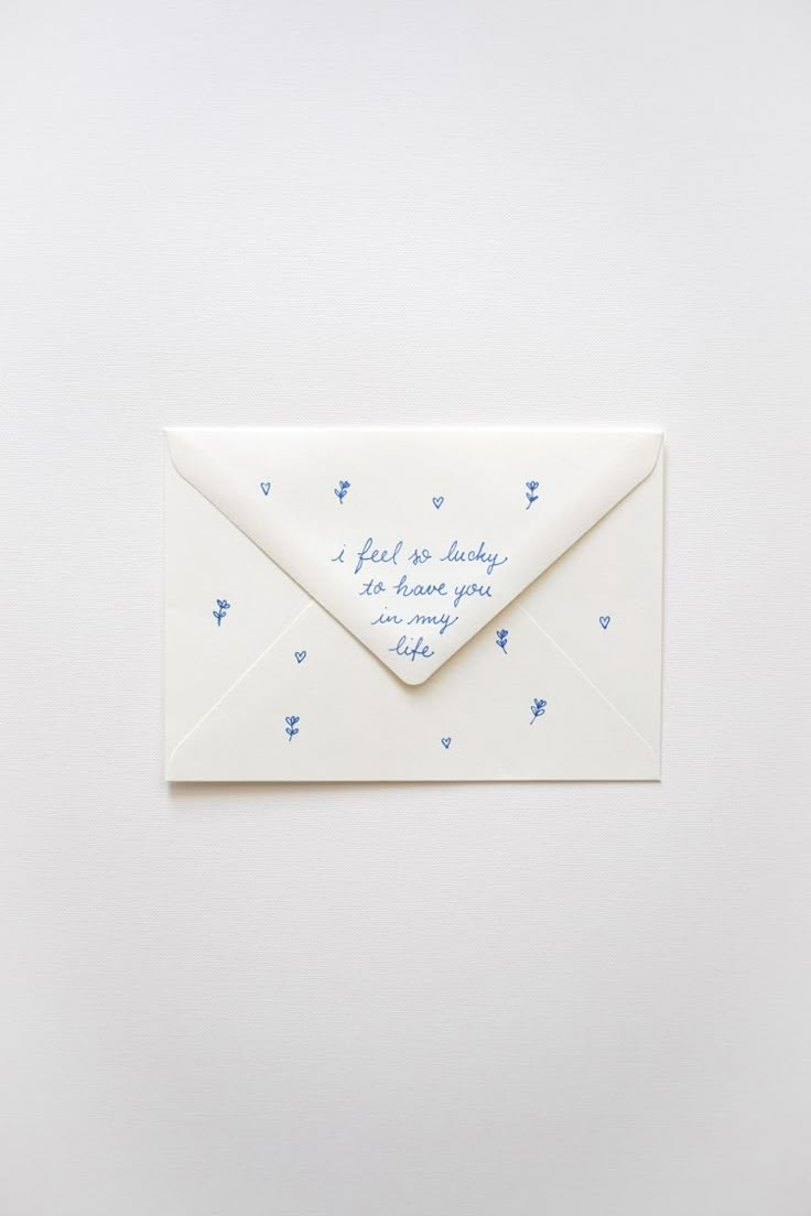 an envelope with a handwritten message on the front, and blue butterflies around it