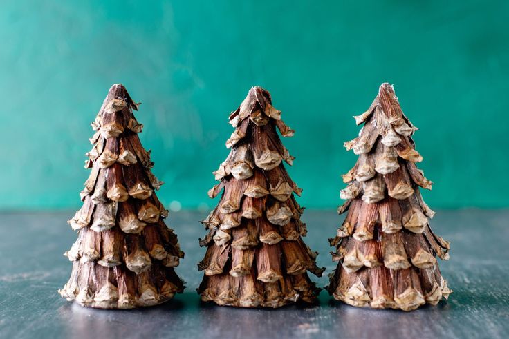 three small wooden trees sitting on top of a table