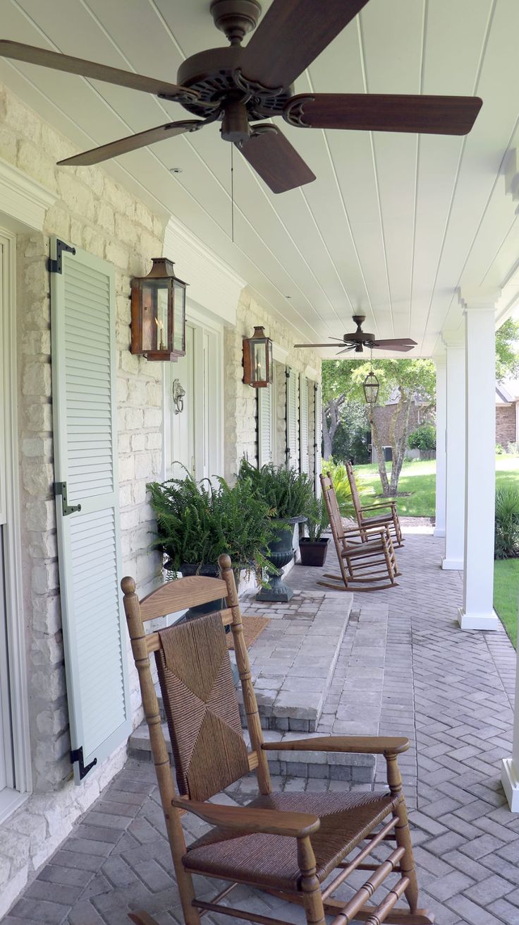 two rocking chairs sitting on the front porch