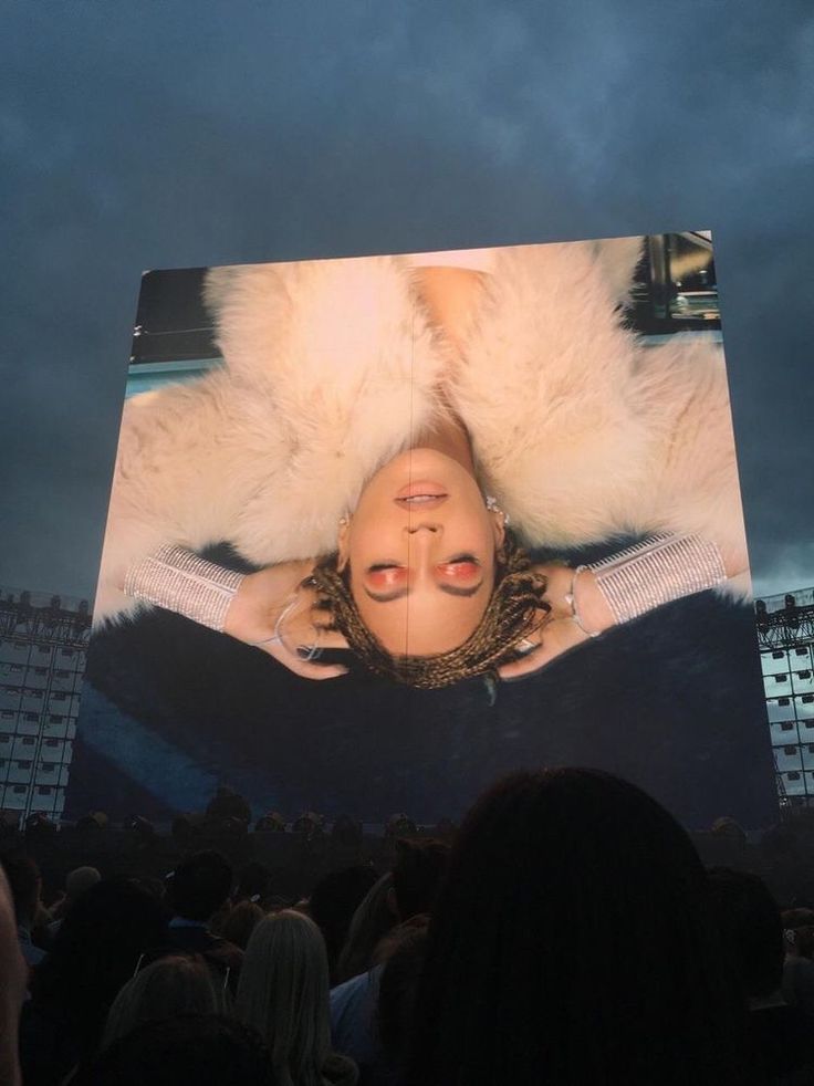 a large screen with a woman's face on it