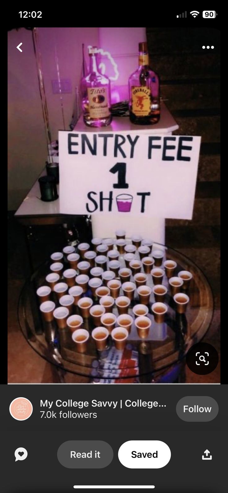 a table topped with lots of cups and a sign that says entry fee 1 shot